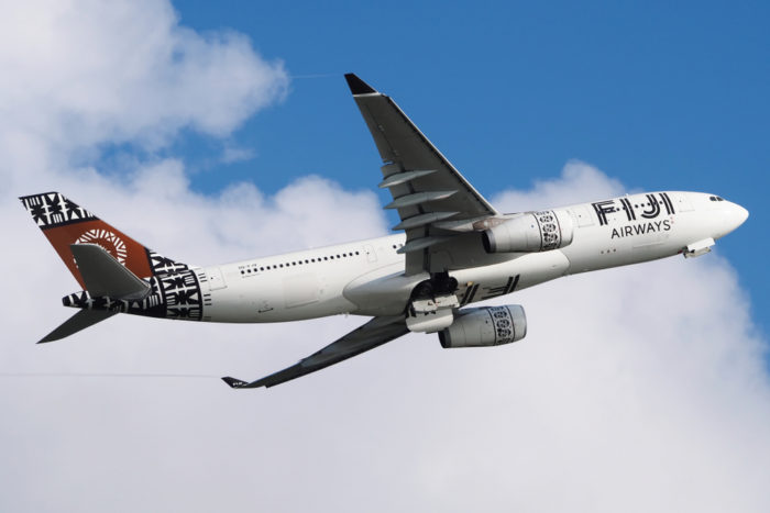 A Fiji Airways plane flying in the sky.